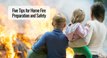 mother and her three children standing outside watching their home burn